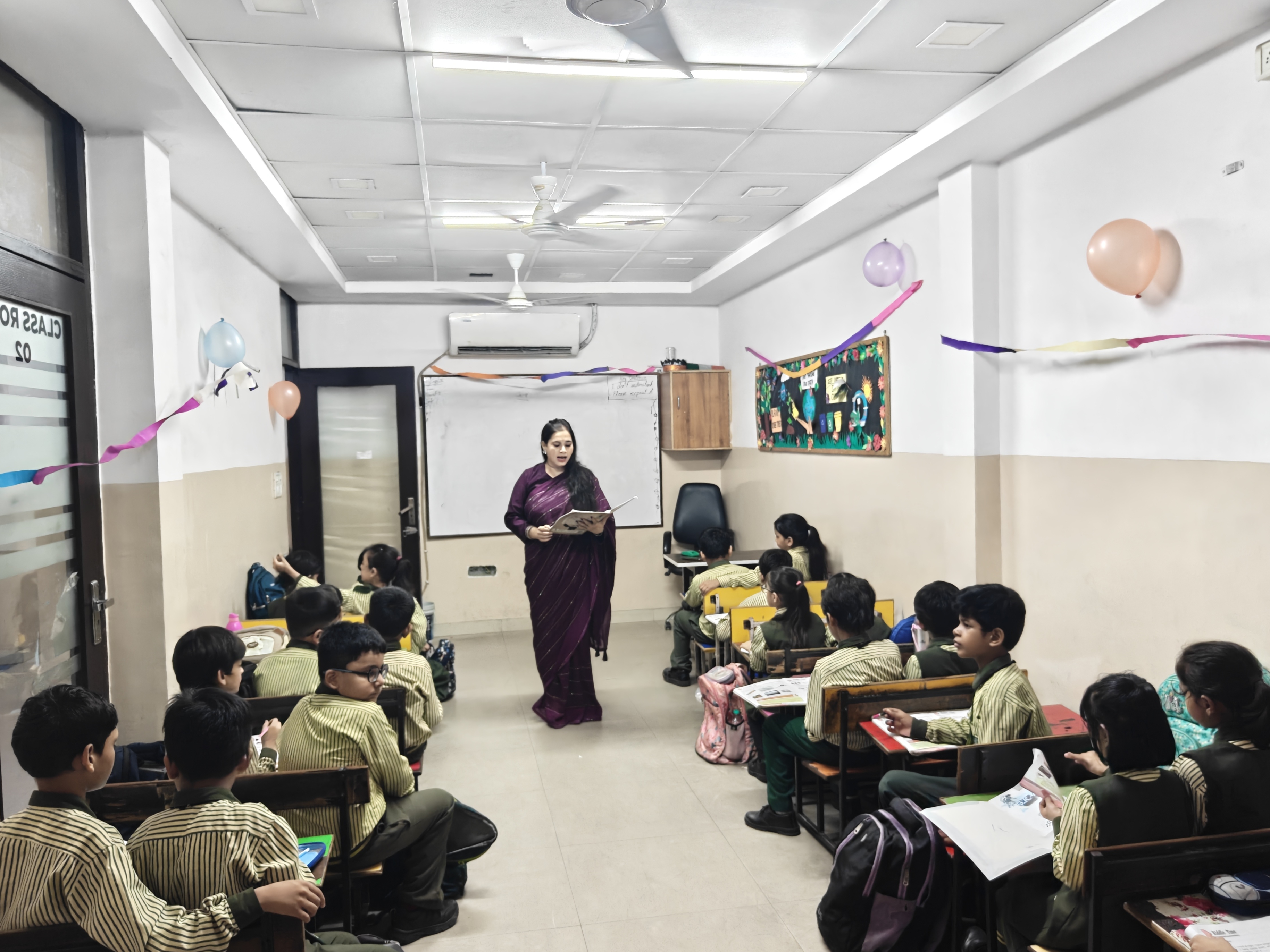 Teacher guiding Garden Public School students
